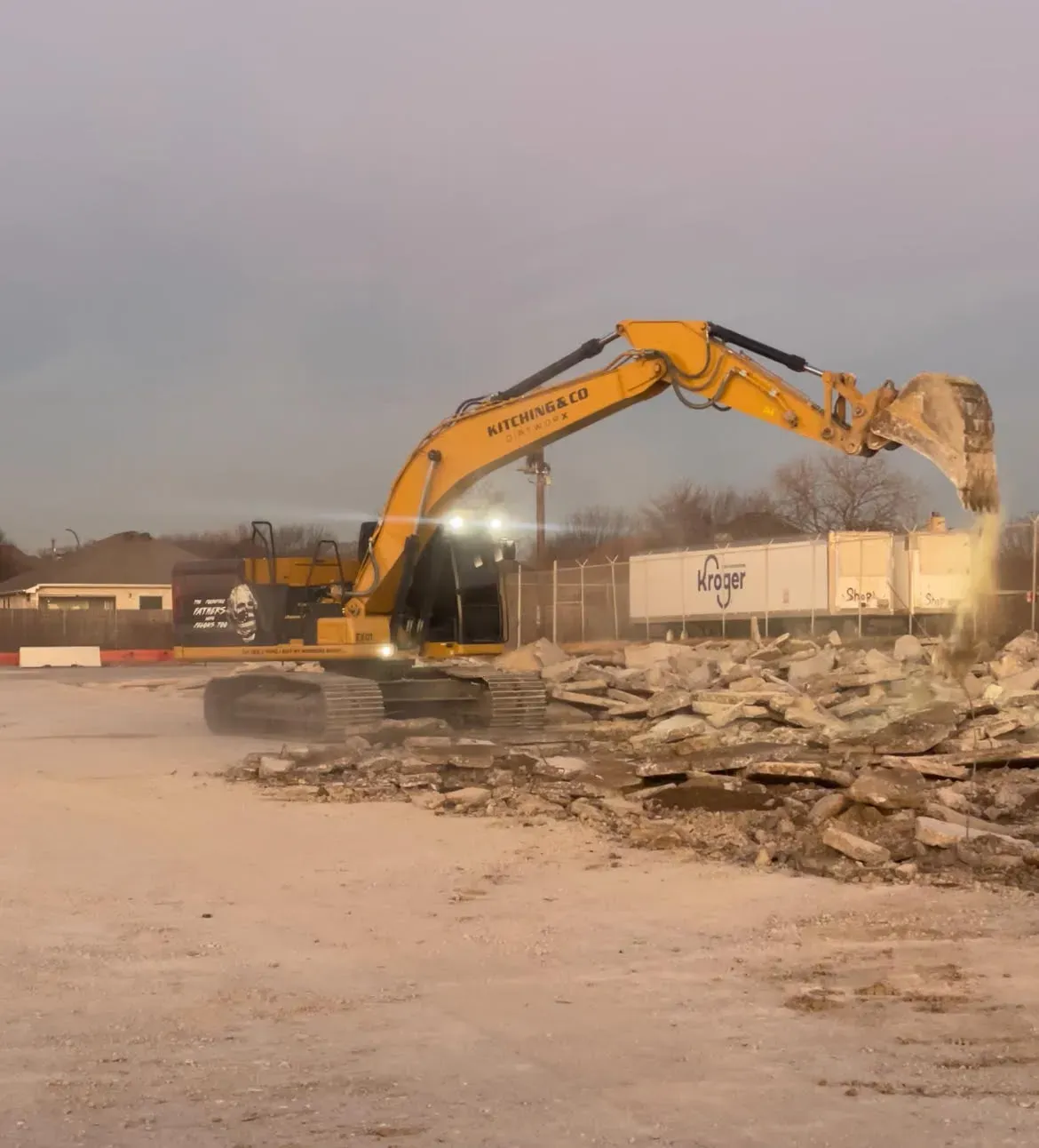 Excavator crew clearing a commercial site
